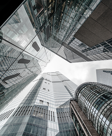 Vertical low angle shot of a modern business building scenery touching the sky